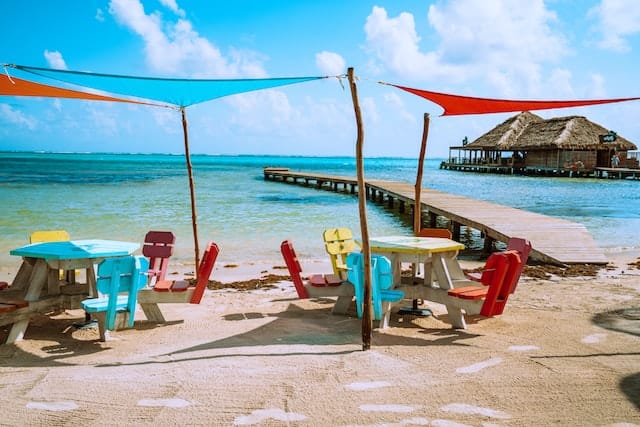 Colorful chairs by the beach in amrbergris caye, belize